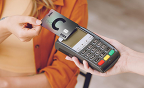 Making a payment with a card using a contactless payment terminal. 