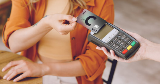Making a payment with a card using a contactless payment terminal. 