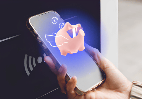 Person pays for a purchase with a phone, and the Citadele app’s smart piggy bank is visible on the screen.