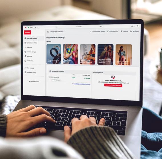 A person is holding a laptop displaying the new design of Citadele Online Bank.
